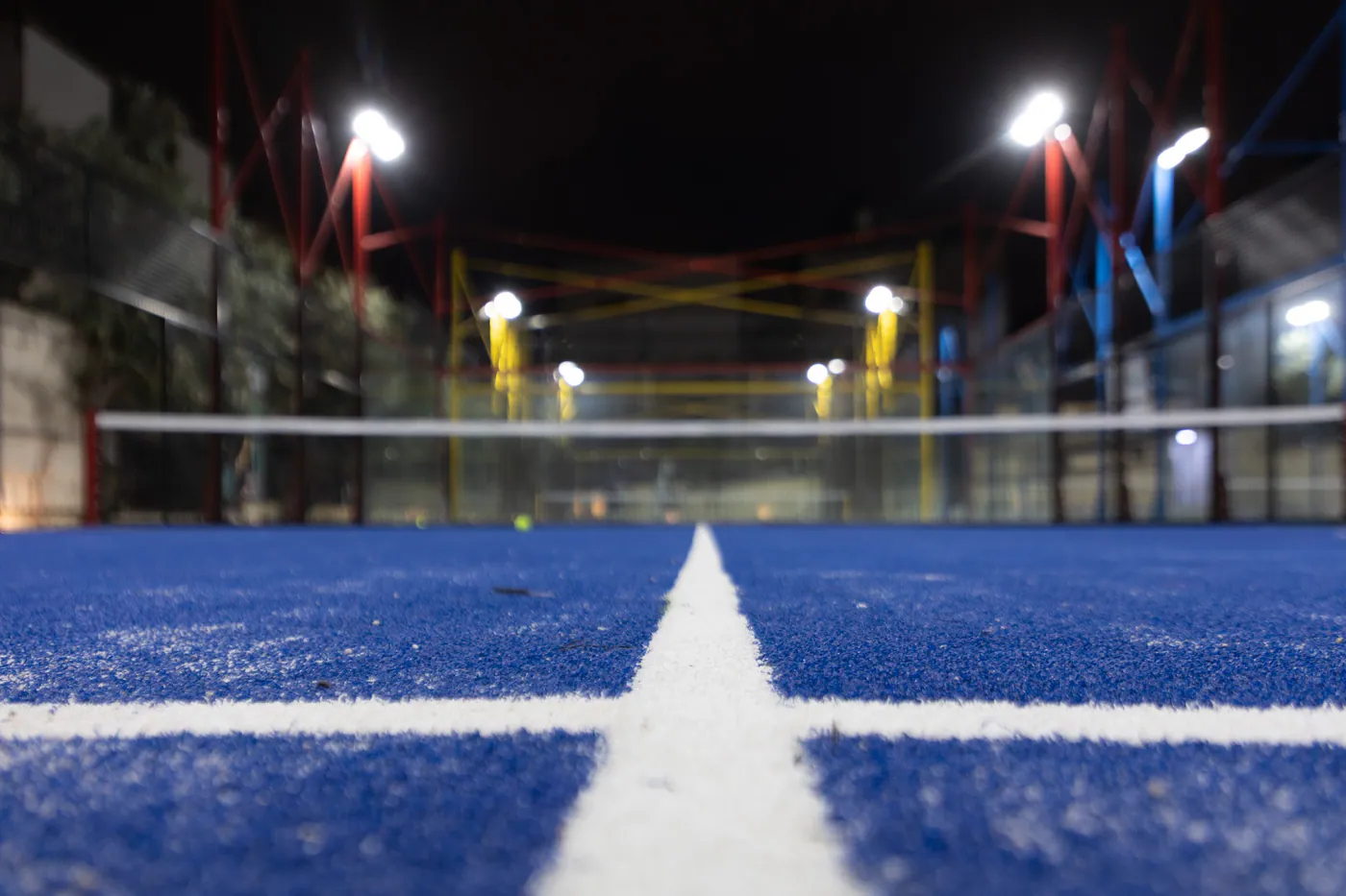 Floodlights over a padel court at The Hub at night